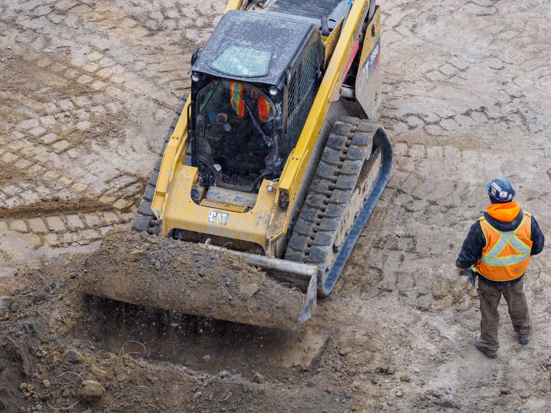 Equipment operator and crew member completing site preparation