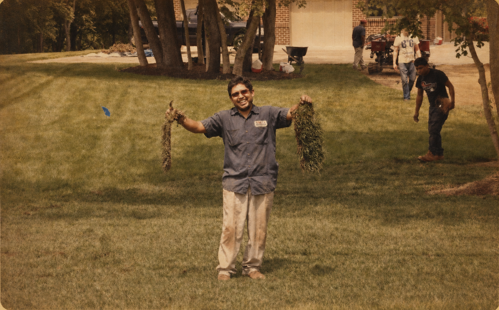 Motz crew member holding sections of turf during an installation