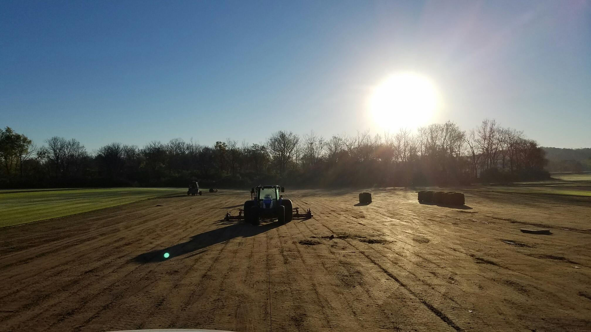 Motz tractor working the turf farm at sunset
