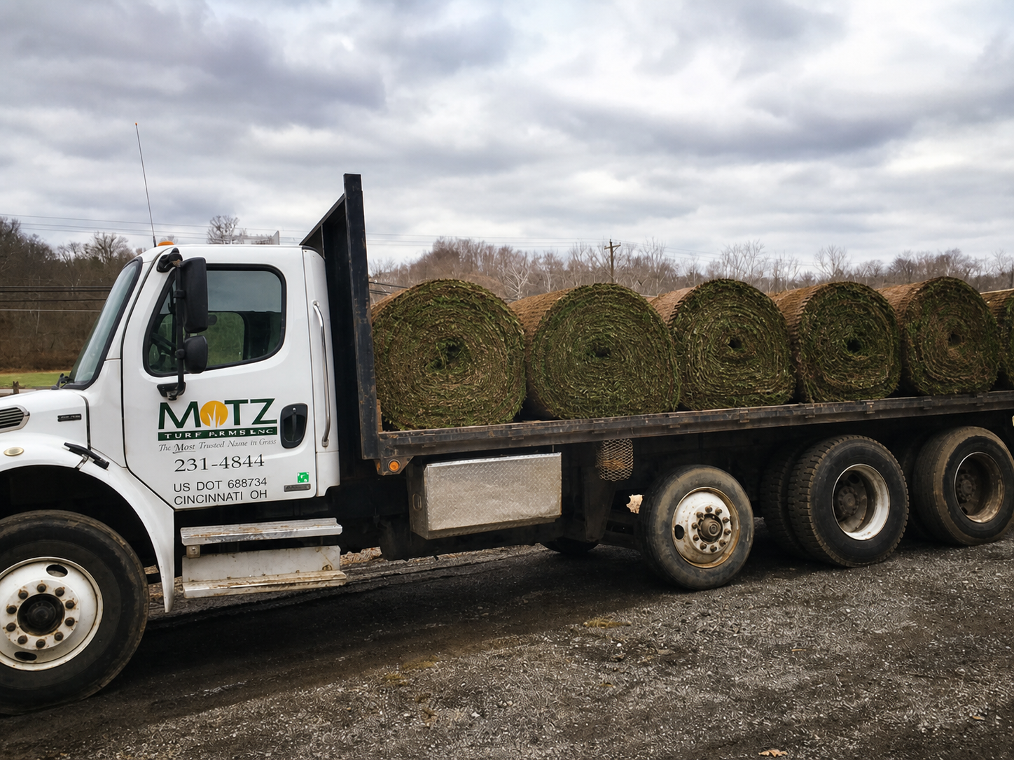 Motz Turf Farms flatbed truck loaded with large rolls of sod